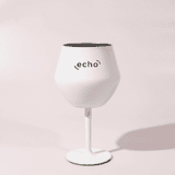 A white Shiraz detachable wine glass with a black interior and a stand, featuring a logo.