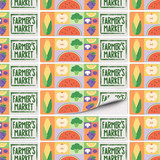 A patterned sheet of stickers featuring various fruits and vegetables in vibrant colours with a logo.