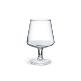 A crystal clear brandy snifter with a wide bowl and a slender stem, showcasing its elegant design.