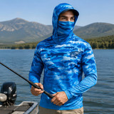A blue camouflage fishing hoodie with a hood and face covering, suitable for sun protection. It includes a logo.