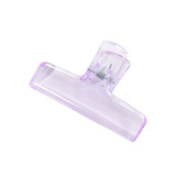 A translucent purple plastic clip with a spring mechanism for securing items.