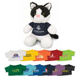 A plush toy cat with black and white fur, wearing a blue shirt with branding, surrounded by various colourful t-shirts.