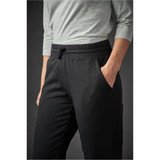 Black women's track pants with an elastic waistband and pockets, styled with a grey top.