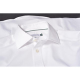 A white button-up shirt with a collar, featuring a branded label inside the neckline.