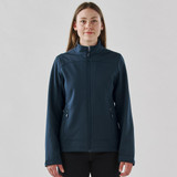 A women's softshell jacket in navy blue with a full zipper and side pockets, featuring a branded logo.
