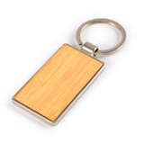 A rectangular bamboo keytag with a zinc metal keyring, featuring a smooth wooden surface.