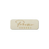 A rectangular wooden badge in light tan with a name engraved on the surface, featuring a subtle, polished finish.