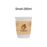 A compostable white paper cup with a brown sleeve featuring illustrations of coffee and a logo.