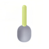 A 2 in 1 pet food scoop with a light green handle and a grey scoop head, featuring a simple design and a logo.