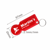 A red custom-shaped trolley coin keyring with a keychain attachment, featuring a branding logo and specific dimensions.