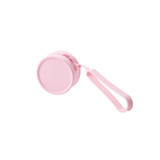 A round pink silicone coin pouch with a zip and a wrist strap. It features a simple design and a branding logo.