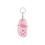 A pink paw-shaped clog shoe keyring with a metal keychain attachment.