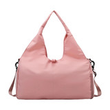 A pink duffle bag featuring a yoga mat strap and a shoulder sling. It has a simple, modern design.