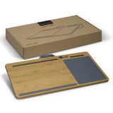A bamboo lap desk in natural colour with a grey area and a logo, positioned next to its cardboard packaging.