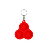 A red silicone keychain with three pop bubbles and a metal attachment ring. It features a smooth surface and rounded design.