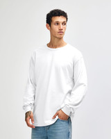 A white heavyweight cotton unisex long sleeve T-shirt displayed on a model, featuring a simple design and branding.