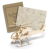 A wooden helicopter model kit in natural colour with assembly instructions on a panel behind it.