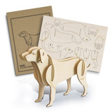 A wooden dog model stands beside its assembly template, crafted from light-coloured wood with detailed cutouts.