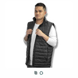 A man is wearing a black puffer vest, standing with his hands on the front buttons. The vest has a sleek design and a collar. A man is wearing a black puffer vest, standing with his hands on the front buttons. The vest has a sleek design and a collar.