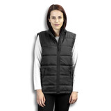 A woman wearing a black puffer vest with a high collar and zip front, styled over a long-sleeve white top. A woman wearing a black puffer vest with a high collar and zip front, styled over a long-sleeve white top.