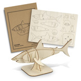 A wooden shark model with a light beige finish, accompanied by a cardboard template and assembly instructions. A wooden shark model with a light beige finish, accompanied by a cardboard template and assembly instructions.