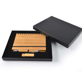 A bamboo notebook with a spiral binding, a bamboo pen, and a USB drive, packaged in a black gift box. A bamboo notebook with a spiral binding, a bamboo pen, and a USB drive, packaged in a black gift box.