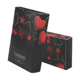 Custom playing cards in a black box featuring red hearts, diamonds, and spades designs, with a logo on the front.