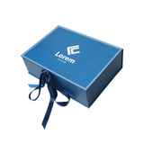 A blue custom gift box with a white logo and a decorative ribbon. The box features a sleek design.