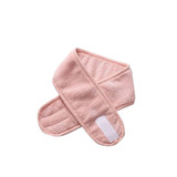 A pink promotional headband with a soft, textured surface and a velcro fastening. It has a branded logo.