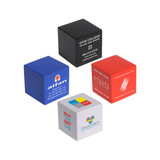 Four cube-shaped stress relievers in red, blue, black, and white, each with a logo or branding.