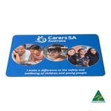 A blue mouse mat featuring three circular images of children and a logo, promoting safety and wellbeing.