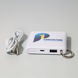 A white power bank with a logo, featuring USB ports and a keyring attachment, accompanied by a charging cable. A white power bank with a logo, featuring USB ports and a keyring attachment, accompanied by a charging cable.