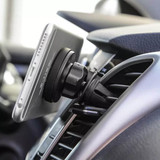A car phone holder in black attaches to a vehicle's air vent holding a smartphone securely in place.