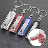 A set of four nail clippers in silver, red, blue, and black, attached to key rings.