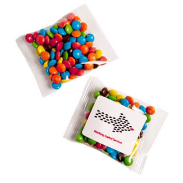 A clear bag filled with Mini M&Ms in various colours, including red, blue, green, yellow, and brown. A clear bag filled with Mini M&Ms in various colours, including red, blue, green, yellow, and brown.