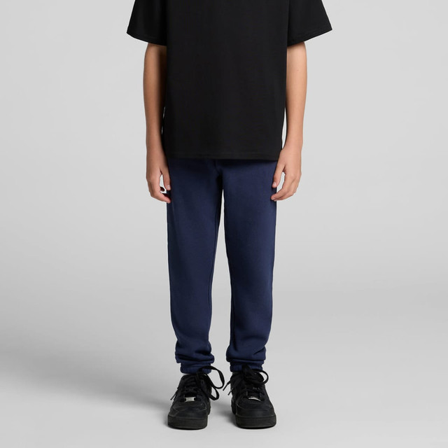Navy blue track pants paired with a black t-shirt and black shoes, featuring a logo on the pants.