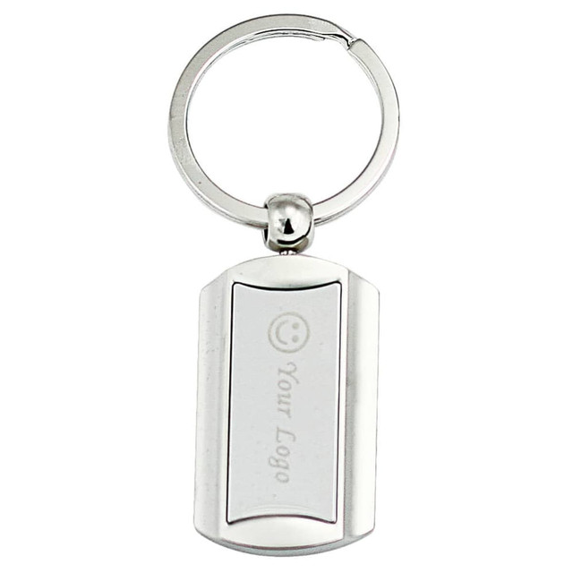 A silver keyring with a rectangular shape and a circular attachment point, featuring a logo design.