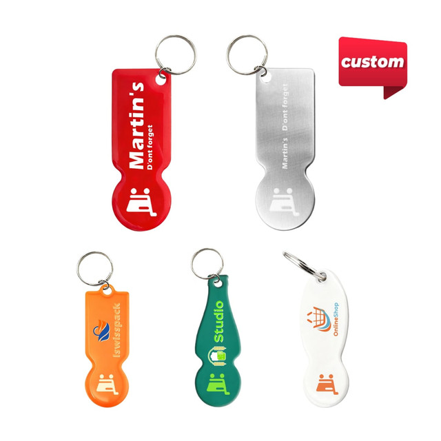 A collection of custom-shaped trolley coin keyrings in red, silver, orange, blue, and green, each featuring a keyring attachment.