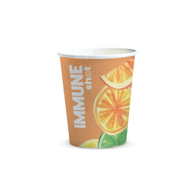 A paper cup with a fruity design, featuring orange slices, in shades of orange and green, with a logo on it.
