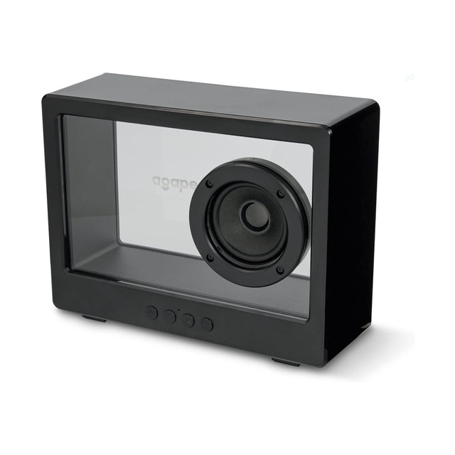 A black speaker with a transparent casing and a round speaker cone visible on one side, featuring control buttons underneath.