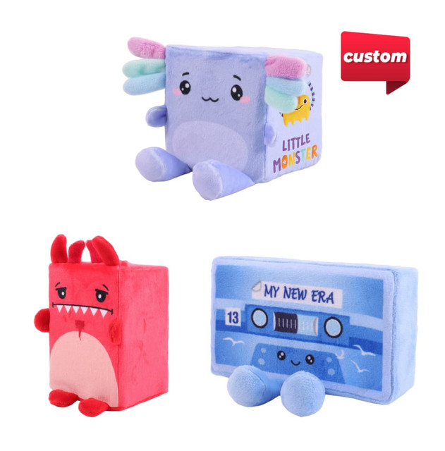 A plush toy set featuring a pastel blue monster, a red monster, and a blue cassette tape. Each has a playful design.