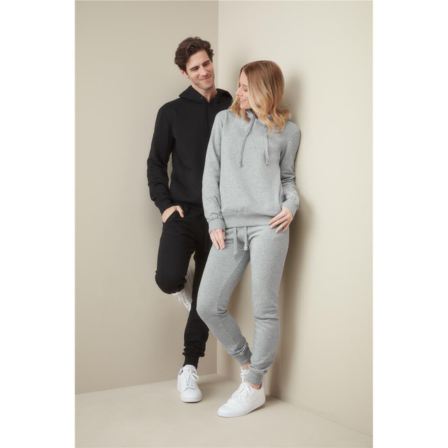 Recycled unisex sweatpants in grey, paired with a black hoodie, worn by a male and female model against a neutral background.
