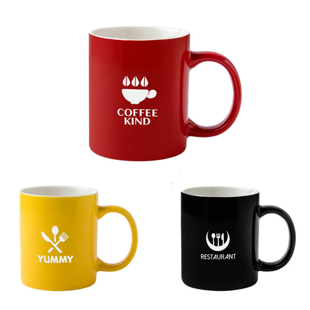 A set of three ceramic mugs in red, yellow, and black, each with a different design and logo.