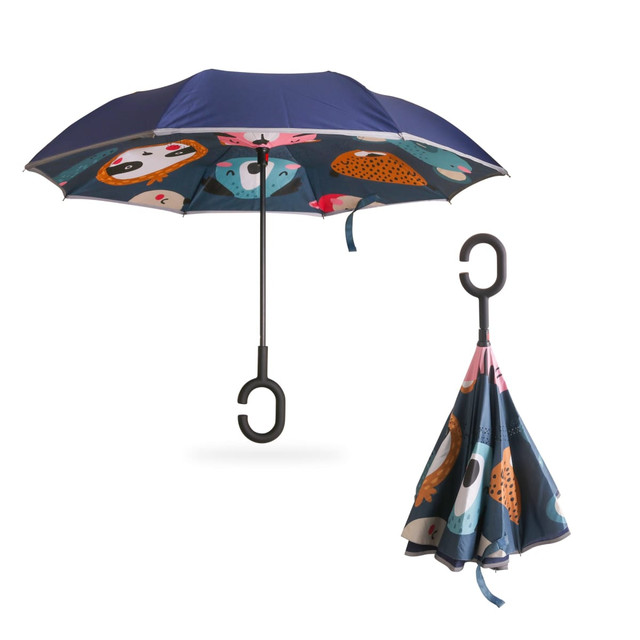 A reversible folding umbrella featuring a navy blue exterior and colourful animal prints on the inside, with a hook handle.