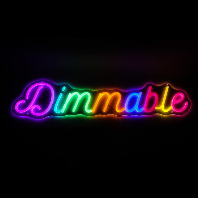 A brightly lit, multicoloured neon LED sign reading "Dimmable" in a curvy font. It features a glowing effect against a dark background.