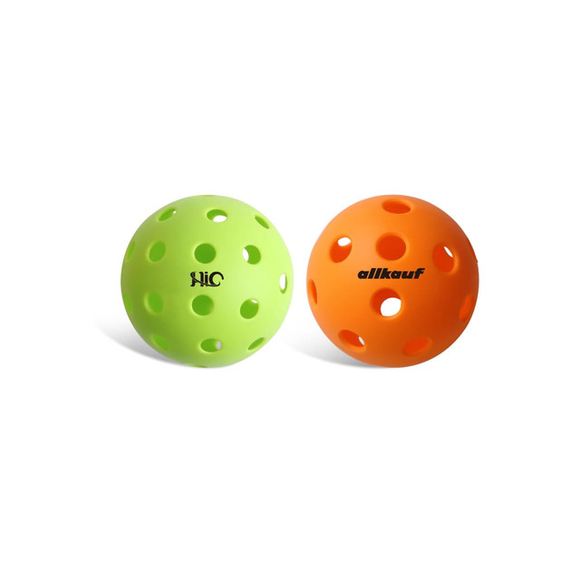 Two pickleball balls, one green and one orange, both featuring multiple holes and a logo on the green ball.