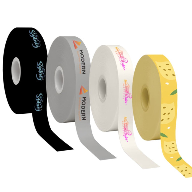 Four rolls of printed cotton ribbon in black, grey, white, and yellow, featuring various designs and a logo.