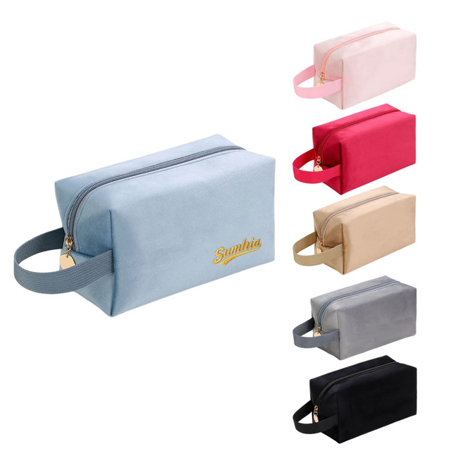 A flannel cosmetic bag in various colours: light blue, pink, beige, grey, and black, featuring a zip closure and a handle.