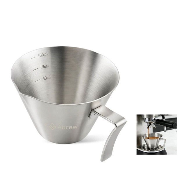 A stainless steel measuring cup with a handle and measurement markings, featuring a sleek, polished finish.