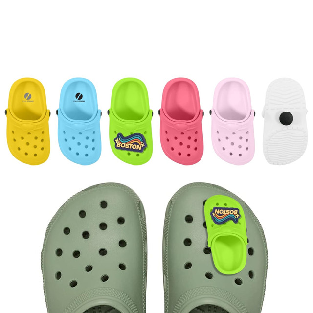 A pair of grey clogs with colourful shoe-shaped charms in yellow, blue, green, pink, and red displayed above.